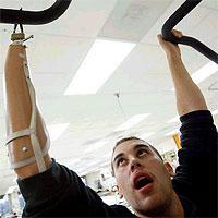 A latino American soldier now wears a prosthesis on his right arm, which ends in a two-pronged claw
